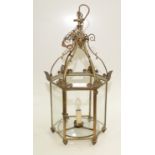 A brass hexagonal hanging lantern, early 20th century, height 63cm.