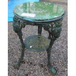 A green painted cast iron pub table, with a later circular plastic top,