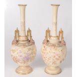 A pair of Royal Worcester blush ivory vases, each with a long tapering neck,