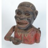 A cast iron 'Jolly Nigger' money box, height 15.5cm, width 13cm.