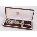 A stylish silver cross and chain by Pleasante Kirk set with baroque pearls amongst gold wire,