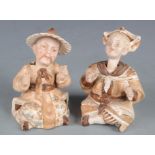 A pair of Chinese porcelain figures, of a seated couple with nodding heads, height 10cm.