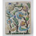 A Persian pottery tile, decorated with three flowering trees and birds, 27 x 21.3cm.