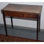 A George III mahogany tea table, the fold over top on square tapering supports, height 74cm,