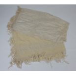 A cream silk embroidered, fringed shawl,