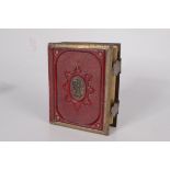 A Victorian photograph album, red leather and brass bound, 15.5 x 12cm.