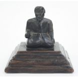 A carved wood figure of a seated man, 19th century, possibly North American,