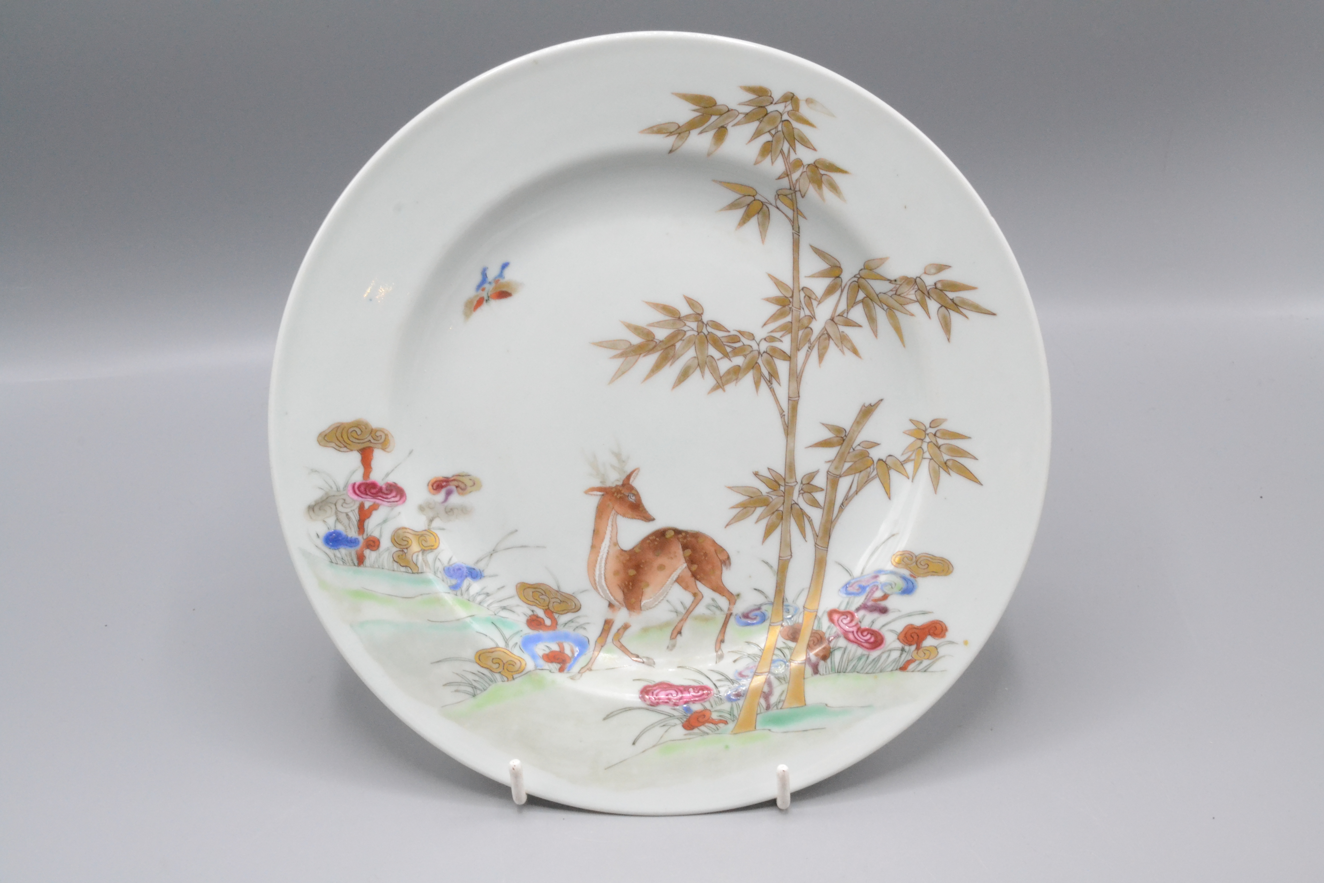 A Chinese export porcelain plate, 18th century, gilt decorated with a deer amongst foliage,