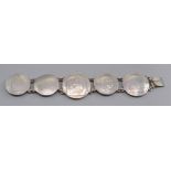 A coin bracelet with three silver thaler and two silver medals 111gms.