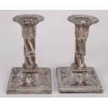 A pair of filled silver late Victorian candlesticks, London, 1883, height 13cm.