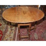 An oak gateleg dining table, part late 17th/early 18th century, the oval top with a carved edge,