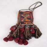 A South East Asian chainstitch and embroidered purse, with metal mounted tassels, length 22.5cm.