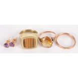 A 14ct gold ring , a gold band , a gold dress ring and a pair of gold earrings.