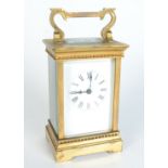 A brass carriage clock,, inscribed 'E.P. Hall from the staff Granada 1936', height of case 12.