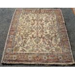 An Indian carpet, the ivory field with an all over design of meandering vines,