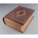 A large leather bound and gilt tooled bible, containing the old and new testaments by Thomas Scott,