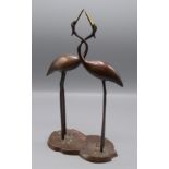 A Japanese bronze group of storks standing on lily pads, their necks entwined, height 31.5cm.
