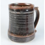 A Leach pottery tenmoku glazed mug, impressed mark to base, height 11.9cm.