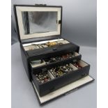 A jewellery box well filled with necklaces and other costume jewellery, including silver.