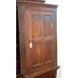 A George III oak corner cupboard, the quadruple panelled single door enclosing three shelves,