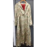 A Chinese silver grey silk robe, early to mid 20th century, decorated with pagodas, boats, people,