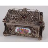A silver casket set with red stones and enamel panels, width 5.8 cm, height 4.2 cm.
