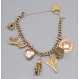 A 9ct gold charm bracelet with a Concorde charm and 18ct gold padlock clasp, 51g.