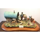 A large Capodimonte porcelain group, entitled 'The Gypsy Caravan', on a shaped wooden plinth,