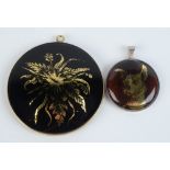 Two silver mounted verre églomisé disc pendants by Frances Federer one showing flowers 6cm and the