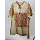 An eastern silk and metal thread over tunic, decorated with floral sprays and leaves, length 101cm.