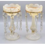 A pair of Victorian gilt decorated milk glass lustres, height 28cm, diameter of top 13.2cm.