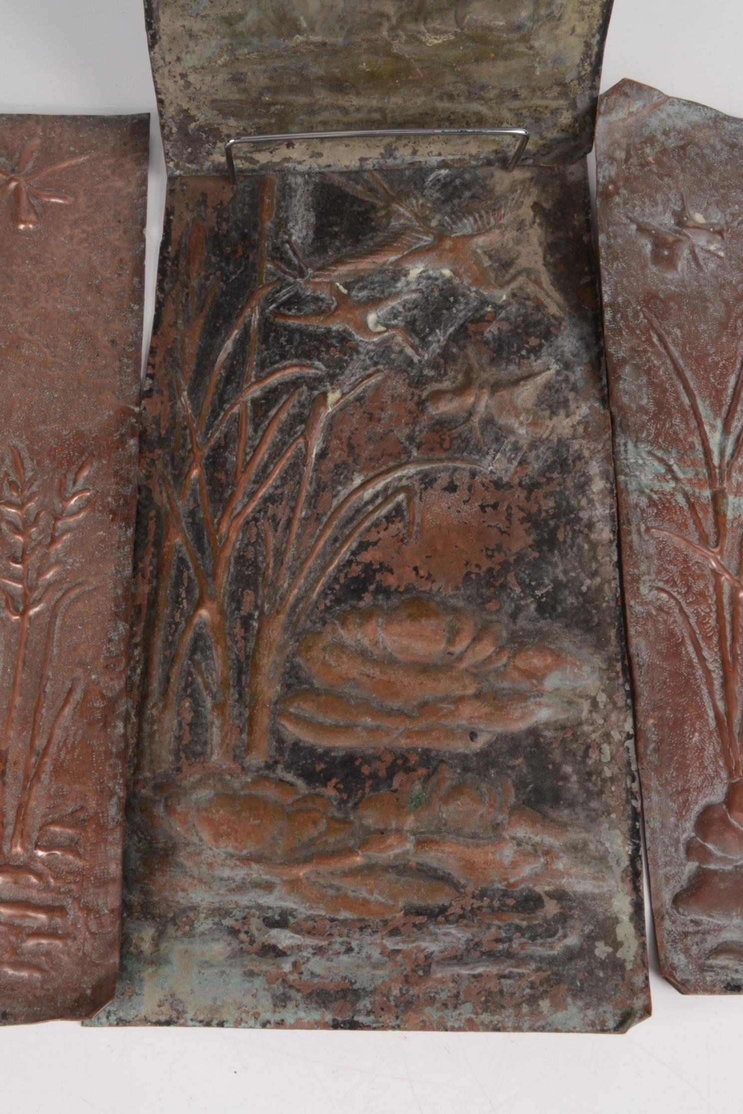 A set of four Arts and Crafts rectangular copper plaques, repousse decorated with reeds, - Image 2 of 3