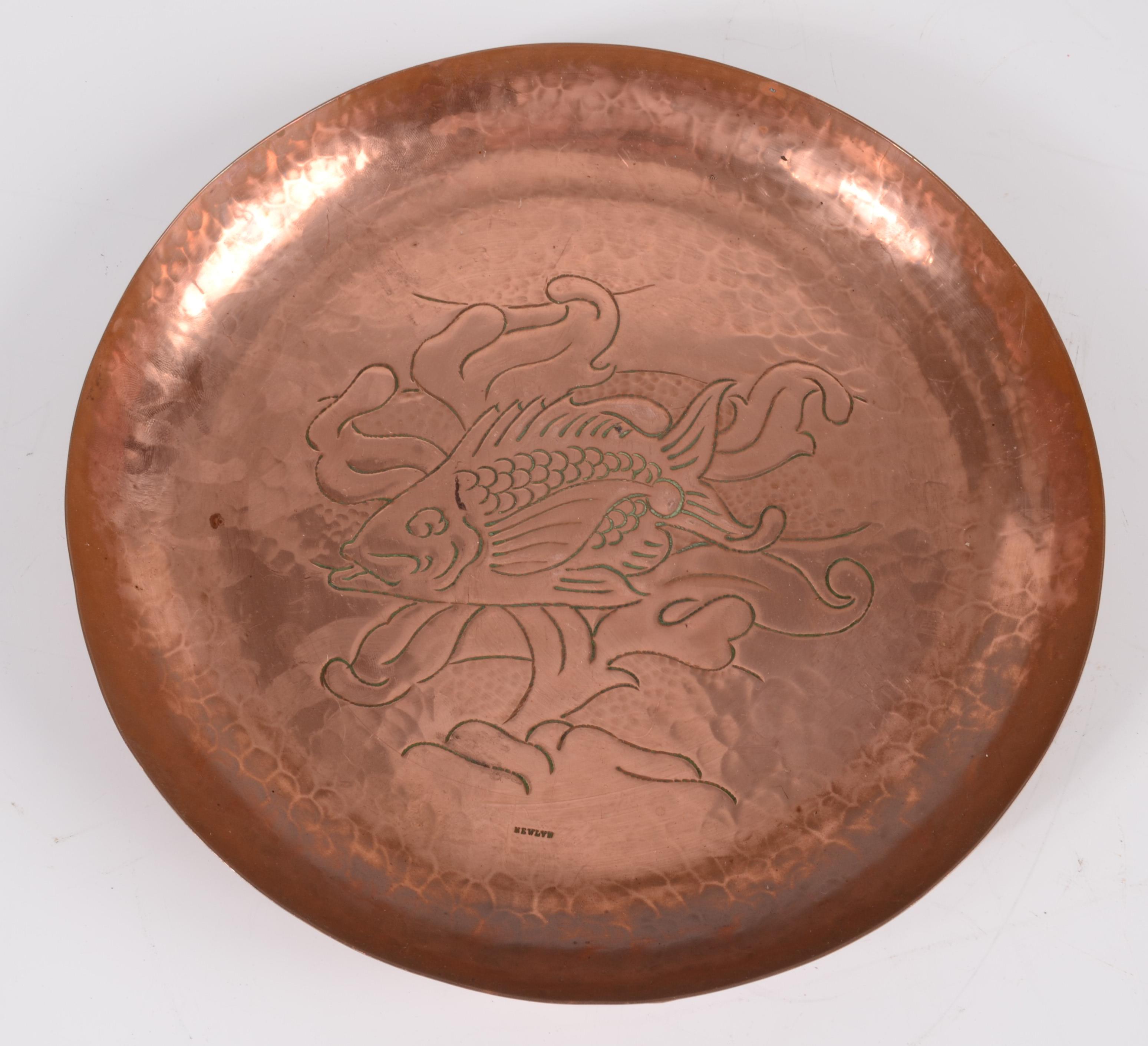 A Newlyn copper circular tray, decorated with a stylised fish amongst seaweed, impressed mark,