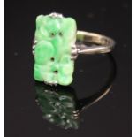 A 9ct white gold ring set a panel of carved jade.
