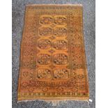 A golden Afghan long rug, with five rows of two octagonal medallions, within a hooked gul border,
