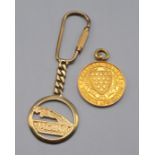 A Cornwall County Swimming Association 9ct gold medal, together with a 9ct gold Jaguar key ring 18.