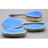 A silver blue enamelled dressing table set.