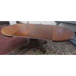 A mahogany extending dining table, 19th century, the oval top on a rectangular column,