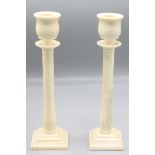 A pair of Anglo Indian ivory candlesticks, 19th century, the baluster stems on square stepped bases,