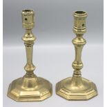 Two brass candlesticks, 18th century, each with a turned tapering stem on a stepped octagonal base,
