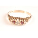 An 18ct gold Edwardian ring set three diamonds and two rubies.