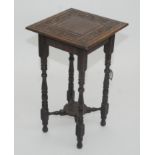 A late Victorian carved oak occasional table, height 72.5cm and two stationary racks.