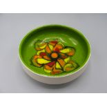 A Poole Pottery footed bowl, the green ground with a central abstract design,