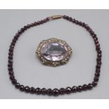 A Cornish Stone Company silver brooch set with amethyst and a faceted garnet bead necklace,