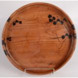 A Japanese circular wood tray, early 20th century, with black painted and gilt leaf decoration,