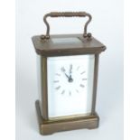 A brass carriage clock, the white enamelled dial with roman numerals, height of case 11cm,