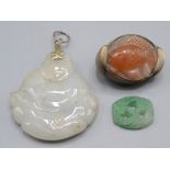 A Chinese jade Buddha carved pendant and two other pieces.
