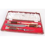 A silver plated and antler handled three piece carving set, the blade inscribed 'Harrods, London,