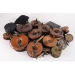 Eleven wooden fishing reels, three brass reels, three other reels and a boxed set of flies.