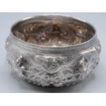 An Indian silver bowl repousse decorated with figures amongst foliage, diameter 11cm, 148g.